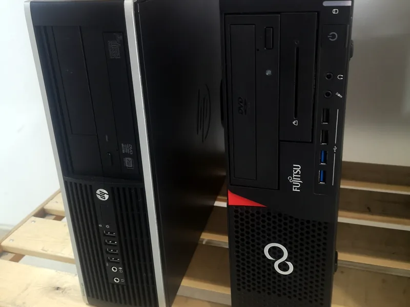 Δύο επαγγελματικοί υπολογιστές HP και Fujitsu σε ξύλινο ράφι
